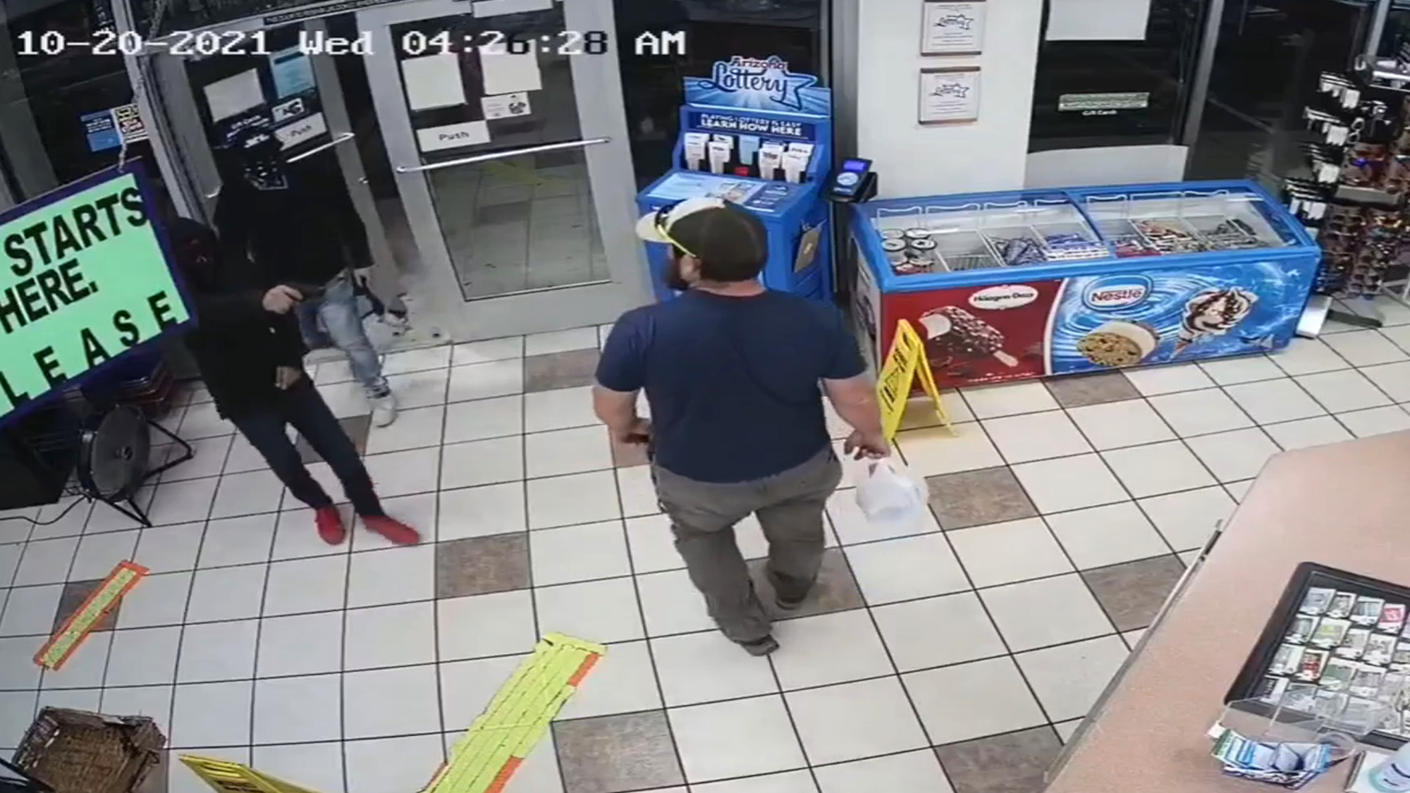 In this screenshot from CCTV, the former Marine (right), who was not identified, in a matter of seconds disarmed and took down the gun-wielding robber to his left, in Yuma, Arizon, on Oct. 20. (Yuma County Sheriff's Office/Zenger)