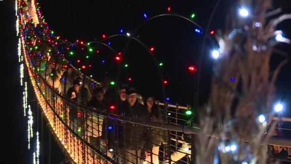 In Gatlinburg, TN, the longest pedestrian suspension bridge in the US has been transformed into a 680 foot tunnel of Christmas lights overlooking the Smoky Mountains.