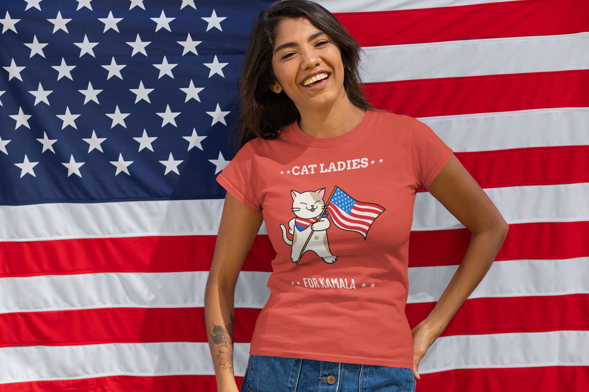Woman wearing "Cat Ladies for Kamala" t-shirt in front of an American flag.