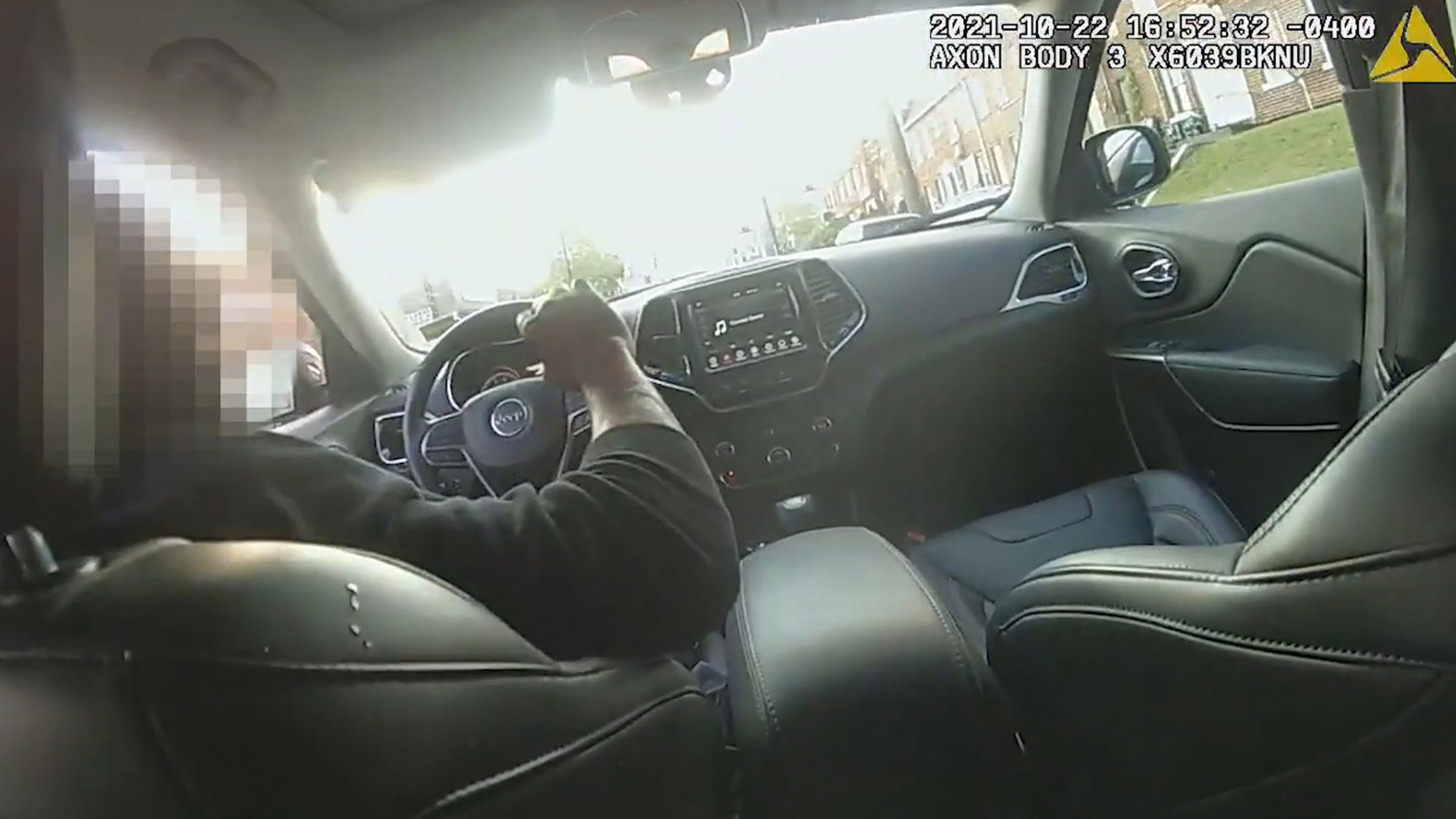 Bodycam video shows a Washington, D.C., police officer caught in the back seat of a moving car. Shortly after this image was taken, the officer shot the driver in the side. (Metropolitan Police Department/Zenger)
