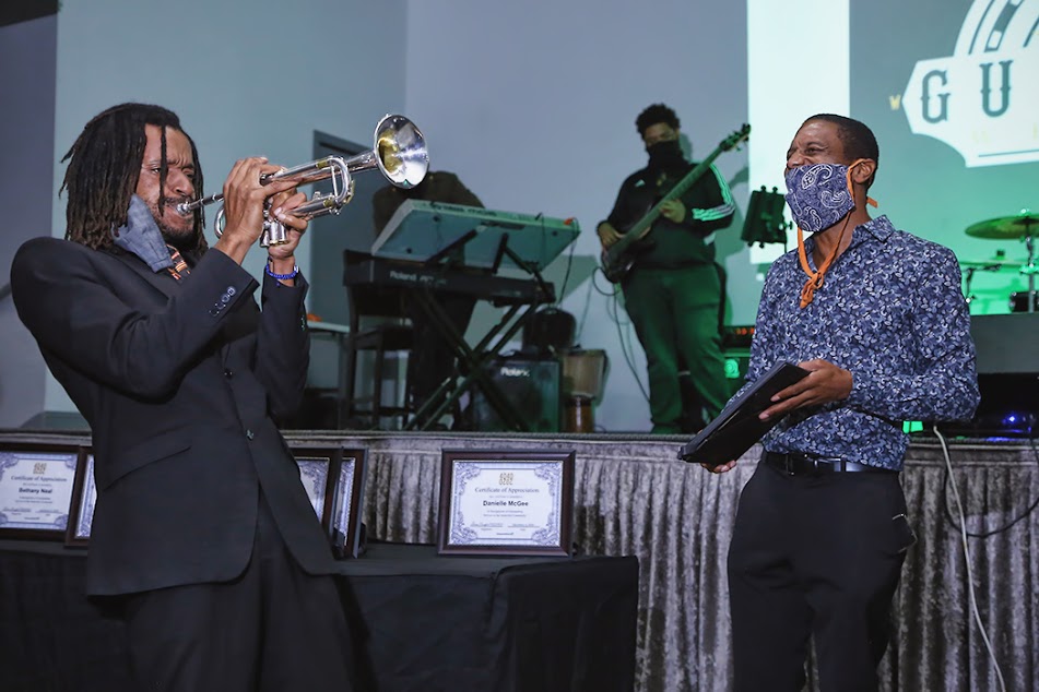 Black 40 Under 40 Founder Shawntaz Crawford (right) enjoying the music of trumpeter Fredrick Weathersby. (Photo by: Deshun Smith)