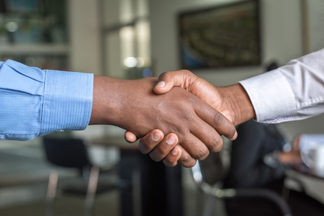 People shaking hands over a successful sale.