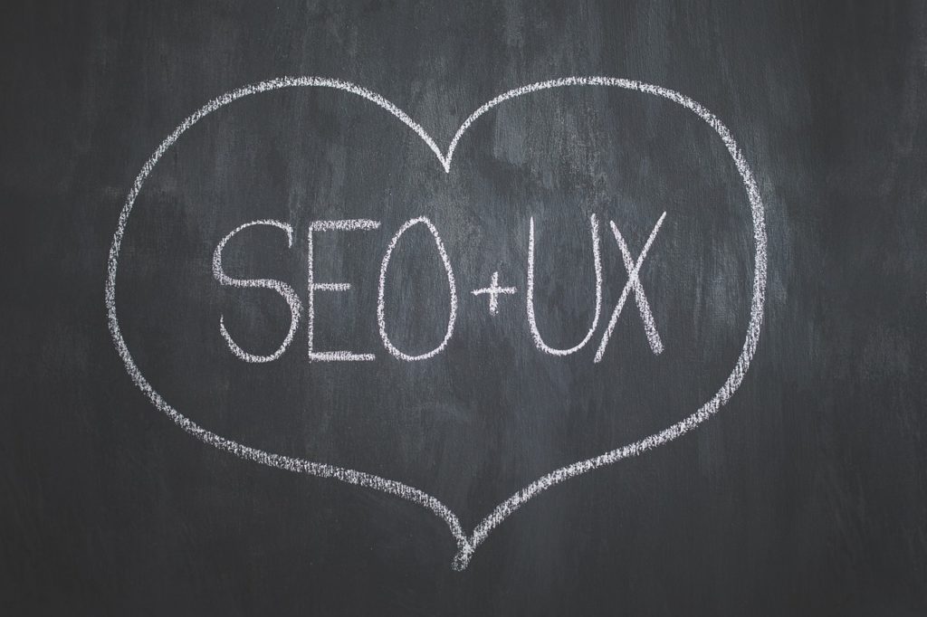 SEO + UX written on a chalkboard, showing one of the advantages of web accessibility.
