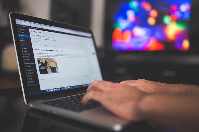 A man writing a blog post using WordPress plugins.