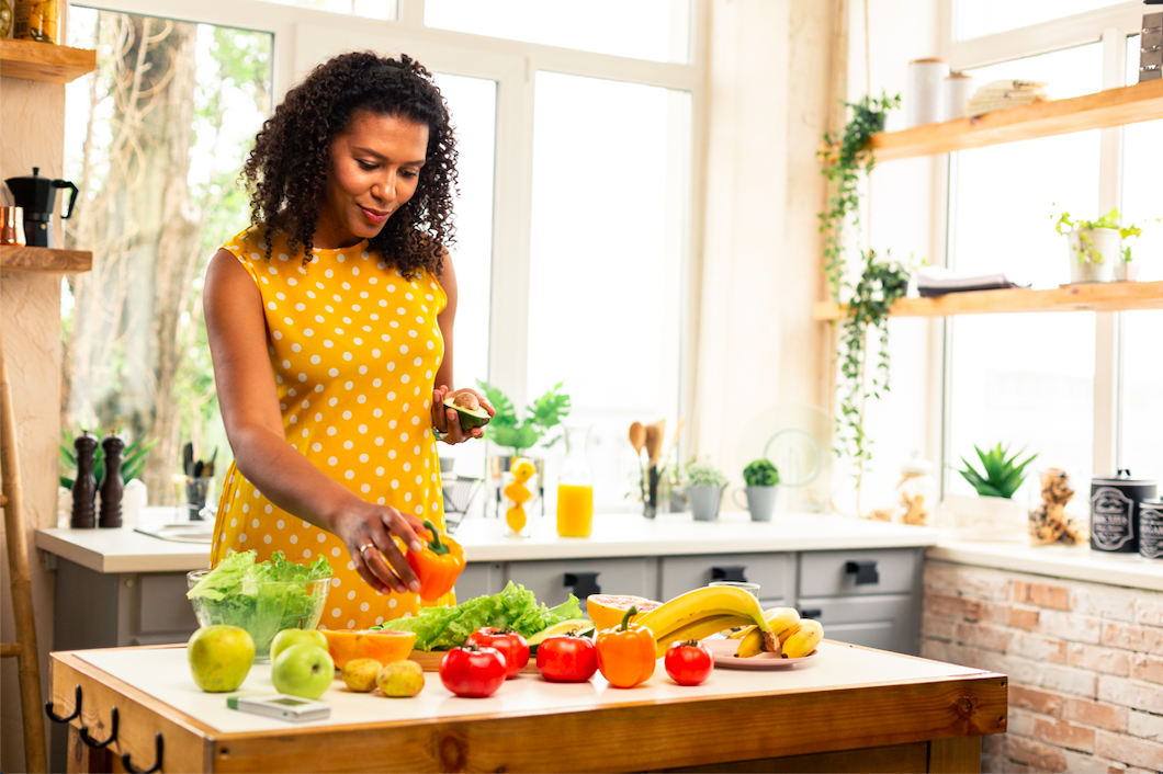 Black woman preparing a healthy meal. (Photo by: Yacobchuk | iStock via Getty Images Plus)