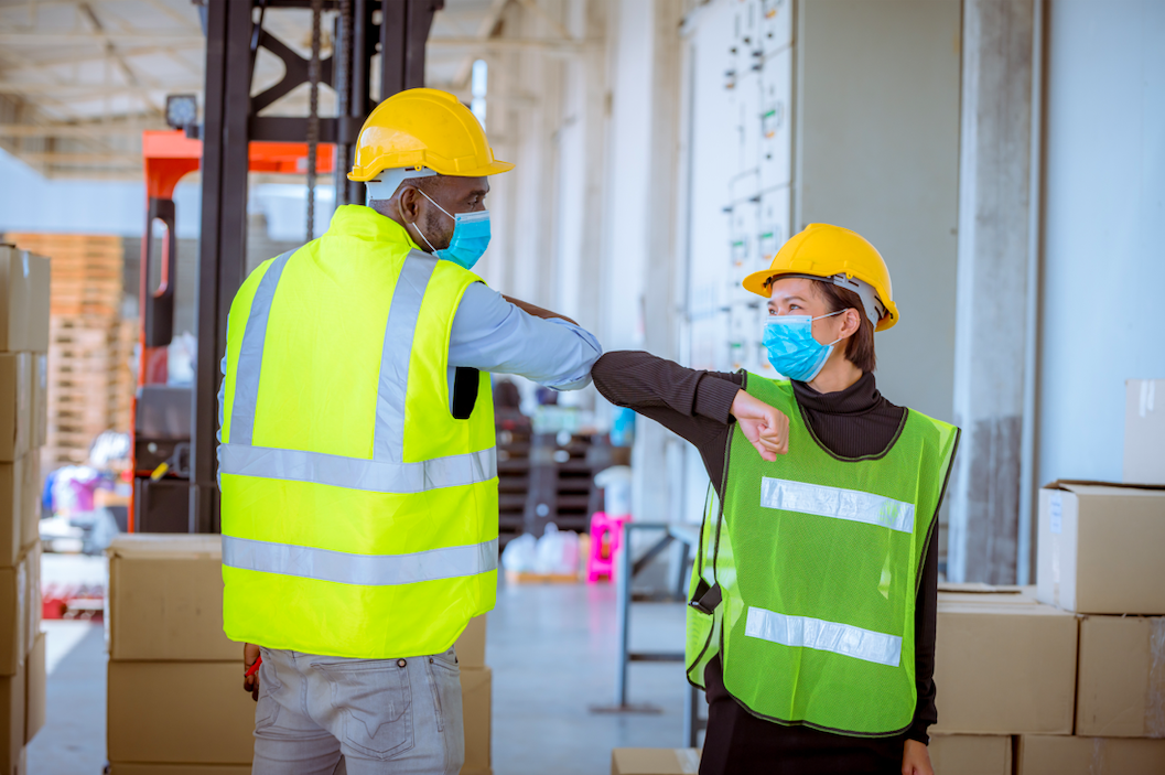 Wearing masks is an important precaution in the workplace. (Photo by: DSCimage | iStock via Getty Images Plus)