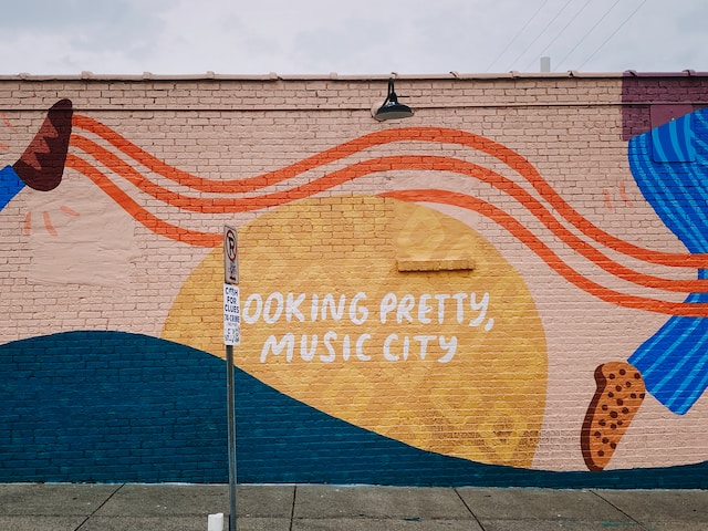 A colorful mural that says LOOKING PRETTY, MUSIC CITY.