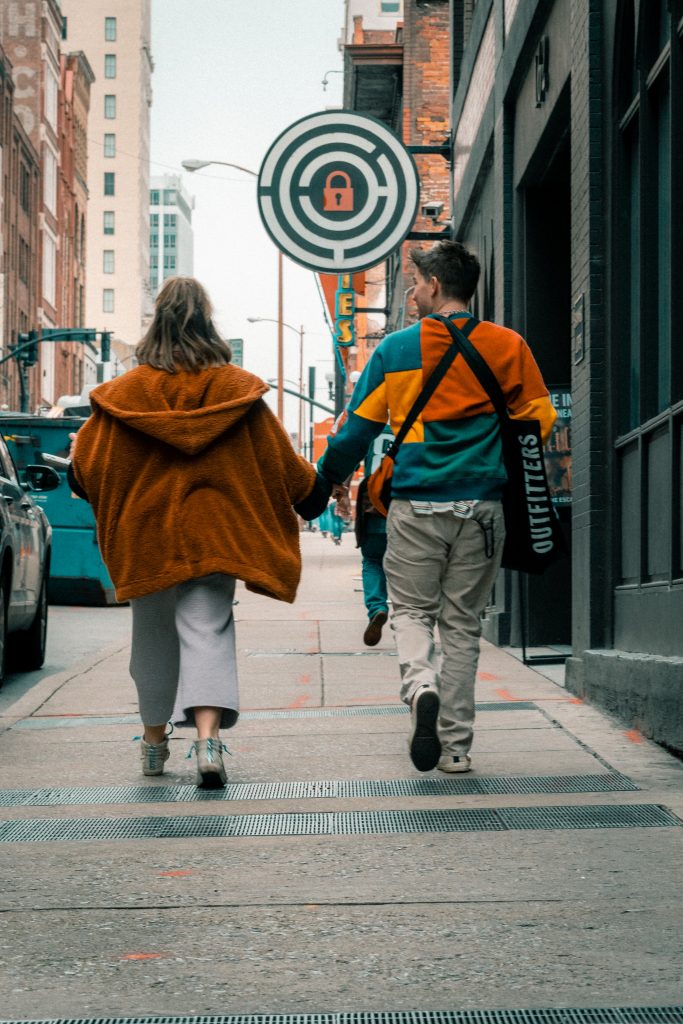 A couple holding hands while walking in Nashville