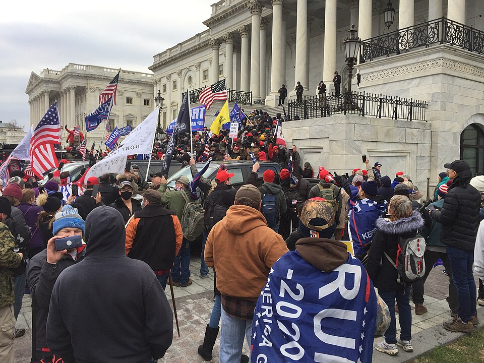 Crowd of Trump supporters gathered outside and on the steps of the U.S. Capitol in Washington, D.C., on January 6, 2021, carrying flags and banners during the events that led to the breach of the Capitol building.