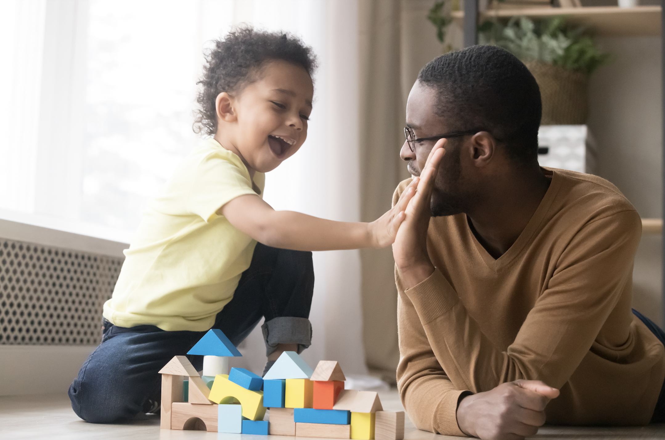 Daughter and father playing together. (Photo by: Fizkes | iStock via Getty Images Plus)