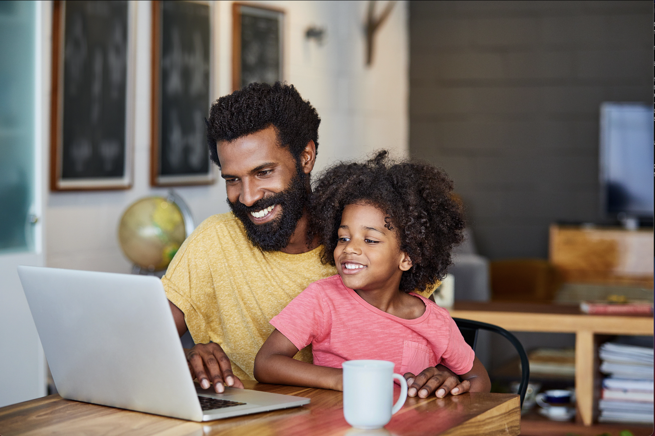 Father and daughter using laptop to access the internet. (Photo by: Kupicoo | Getty Images)