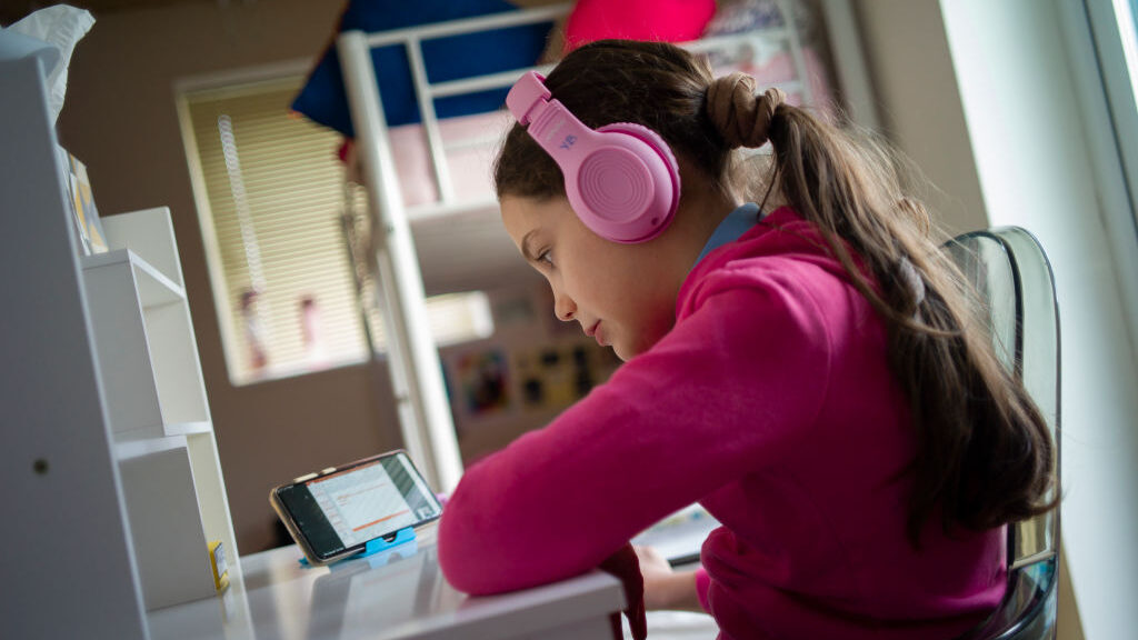 A student takes part in an online class at home on January 28, 2021 in London, England. As the COVID-19 pandemic drove schools and businesses online, it also drove crime online. (Dan Kitwood/Getty Images)
