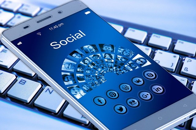 a phone with Social written on top of the screen and social medial icons below