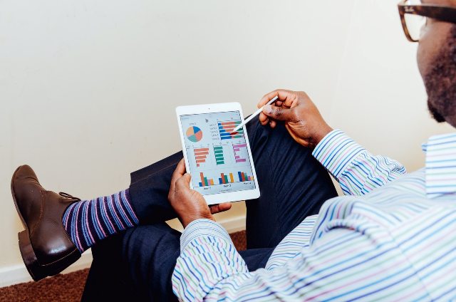 A man checking website metrics on a tablet.