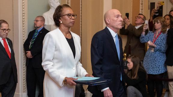 House Sergeant at Arms Paul Irving and Clerk of the House Cheryl Johnson carry the articles of impeachment against President Donald Trump to Secretary of the Senate Julie Adams on Capitol Hill in Washington, Wednesday, Jan. 15, 2020. Following are impeachment managers, House Judiciary Committee Chairman, Rep. Jerrold Nadler, D-N.Y., House Intelligence Committee Chairman Adam Schiff, D-Calif., Rep. Hakeem Jeffries, D-N.Y., Rep. Sylvia Garcia, D-Texas, Rep. Val Demings, D-Fla., Rep. Zoe Lofgren, D-Calif., and Rep. Jason Crow, D-Colo. (AP Photo/Manuel Balce Ceneta) , Wednesday, Jan. 15, 2020. (AP Photo/Manuel Balce Ceneta)
