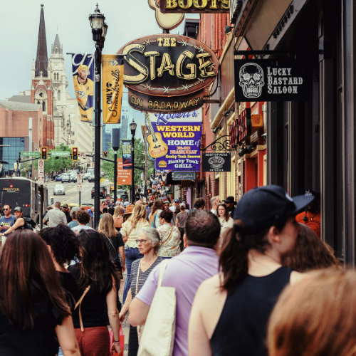 Crowds fill Lower Broadway in downtown Nashville during CMA Fest as visitors gather outside popular music venues, bars, and entertainment destinations.