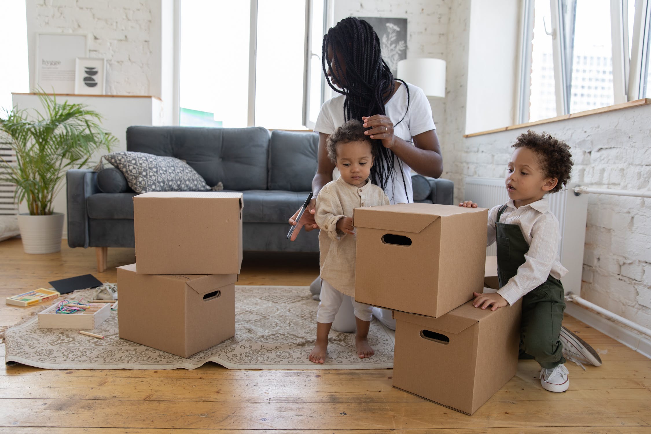 mom and kids packing boxes
