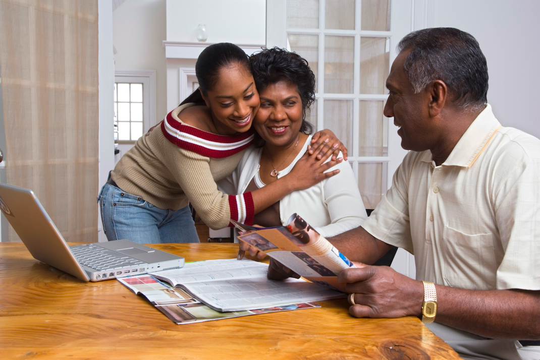 Parents discussing college with their daughter (Photo by: Creatas Images / iStock via Getty Images Plus)