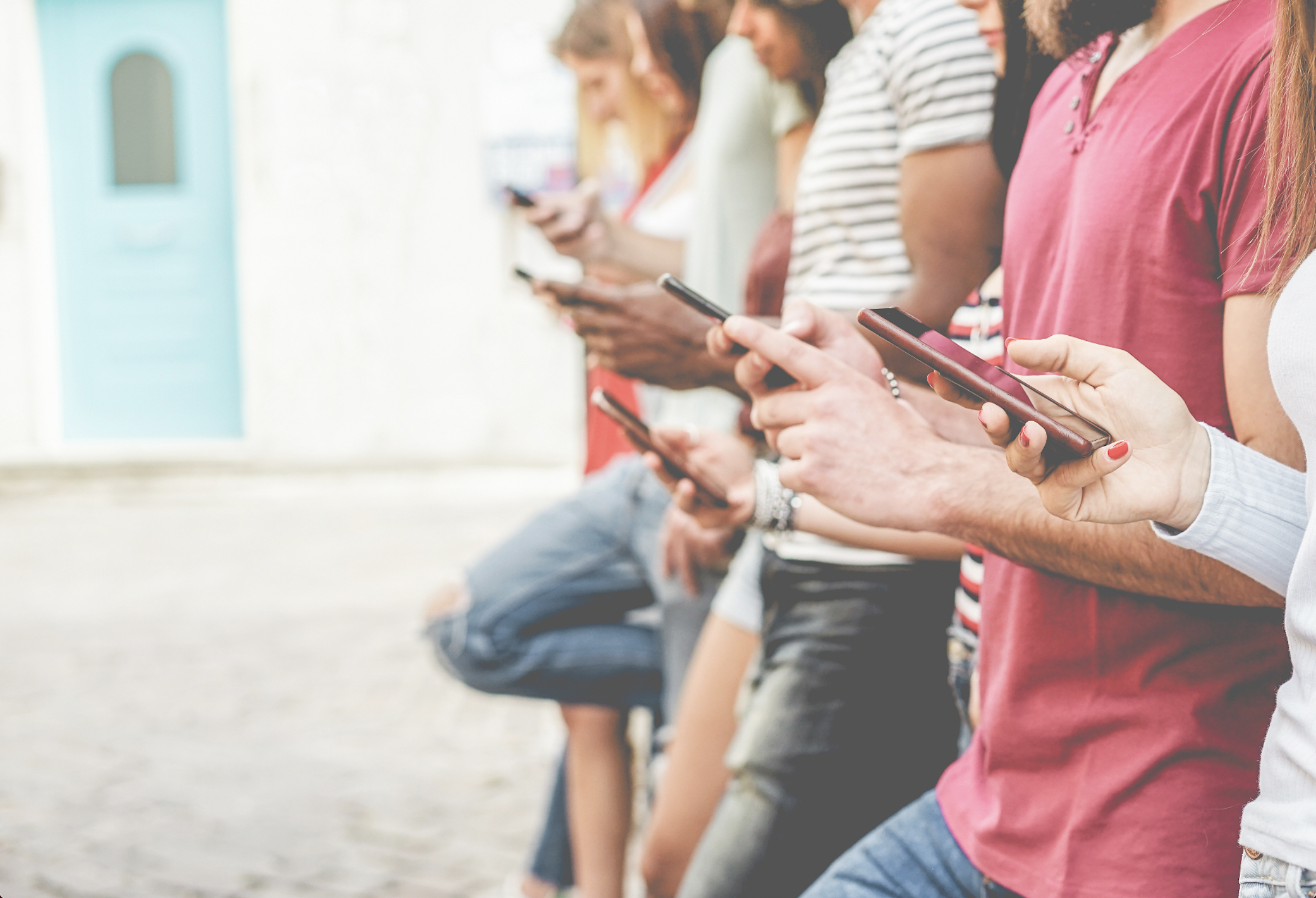 Group of teenagers on their mobile devices. (Photo by: DisobeyArt | iStock via Getty Images Plus)