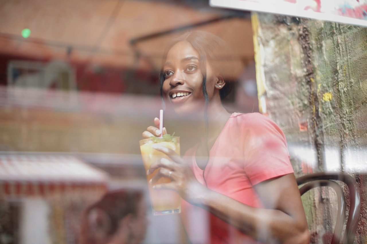 A woman having a cocktail in a bar