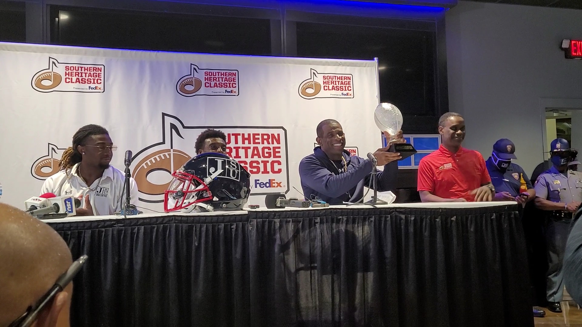Jackson State Coach Deon Sanders holds up Southern Heritage Classic Trophy.