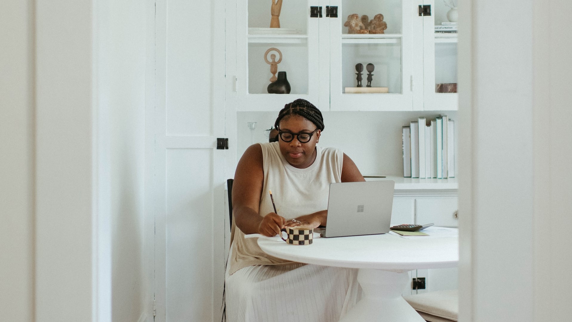 A small business owner sits at her desk.