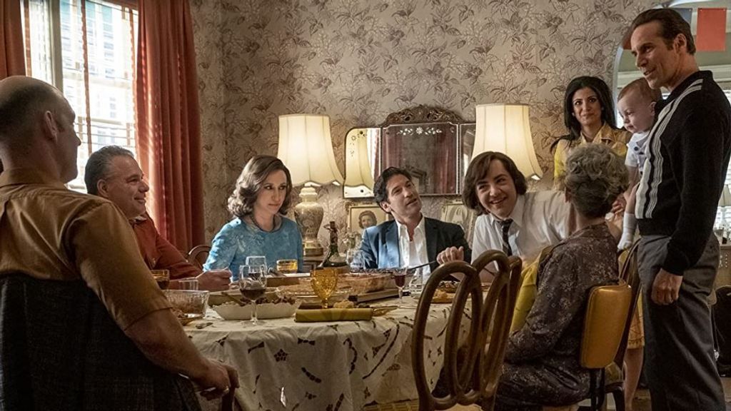 Michael Gandofini (seated with tie) plays a younger version of Tony Soprano, the character his real-life father made famous in the original “Sopranos” series. (Warner Bros.)