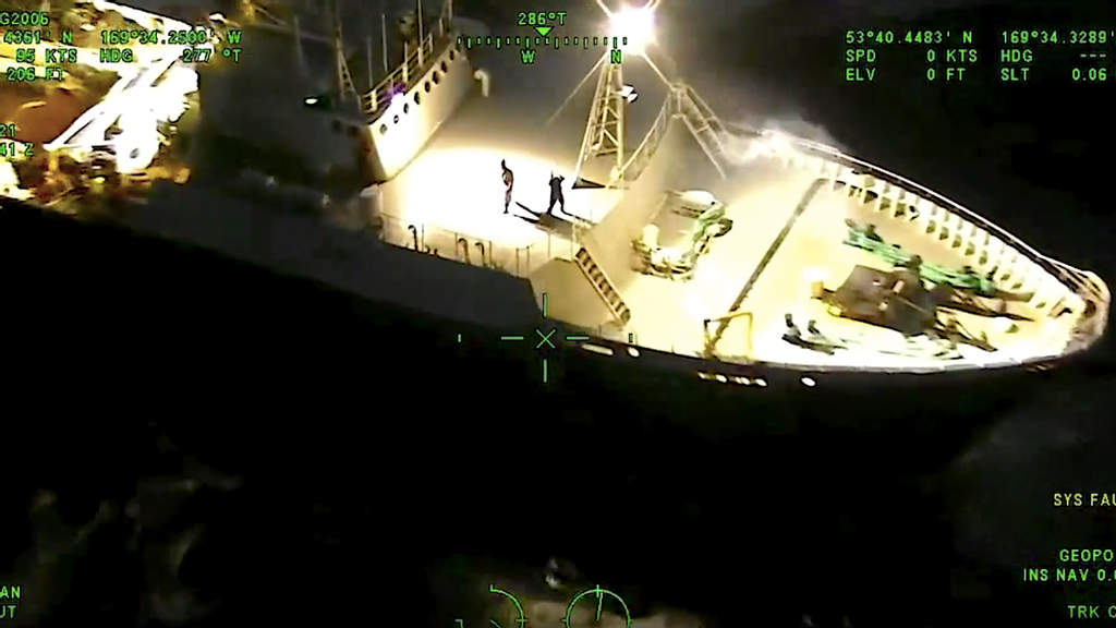 Crew onboard the fishing vessel await the air drop of oxygen cannisters. (U.S. Coast Guard/Zenger)