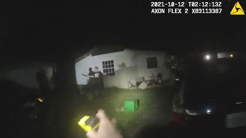 Shawn Loncala is shown at the center of this photo surrendering to sheriff's deputies in Holly Hill, Florida. He led authorities on a lengthy foot chase through several backyards and into at least one home. (Volusia Sheriff's Office/Zenger)