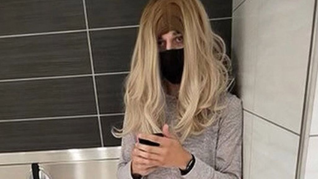 Photo purportedly showing Jacob M. Guerrero posing as a woman and wearing a wig, in a women's bathroom at the Wrentham Outlet in Wrentham, Massachusetts. (Wrentham Police Department/Zenger)