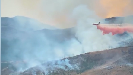 A tanker jet drops a fire-retardant chemical on the Crown Mountain Fire in Montana's Helena-Lewis and Clark National Forest. (Helena-Lewis and Clark National Forest/Zenger)