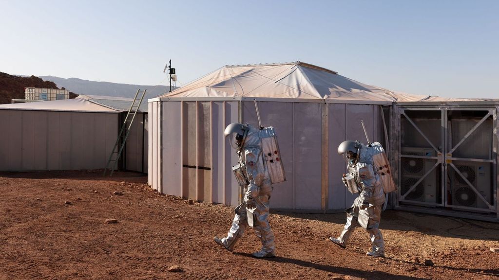 The astronauts walk past their intended habitat in the Israeli desert, in a simulation of being on Mars. (Florian Voggeneder/OeWF)