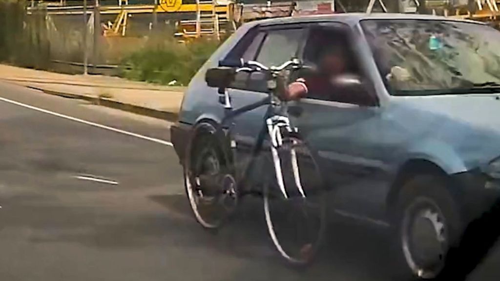 A man drove his car with his left hand and held a bicycle outside the driver’s window, wheeling it along as he drove on Nov. 2 in Maryborough, Australia. (Queensland Police/Zenger)