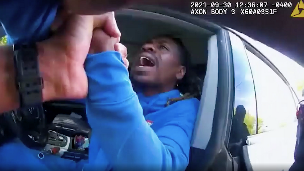 A Dayton, Ohio, police officer begins to remove Clifford Owensby from his car after Owensby, a paraplegic, repeatedly refuses to exit the car and refuses the officer's offer to assist him. The incident on Sept. 30 was filmed on police bodycam video. (Dayton Police/Zenger)