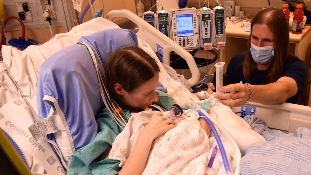 Candice and Collin Cruise feed 8-day-old Cameron at Toronto General Hospital on June 18. A team of specialists saved the mother by using an artificial lung device to keep her alive through the early delivery. She then received an urgently needed double-lung transplant. (University Health Network/Zenger)