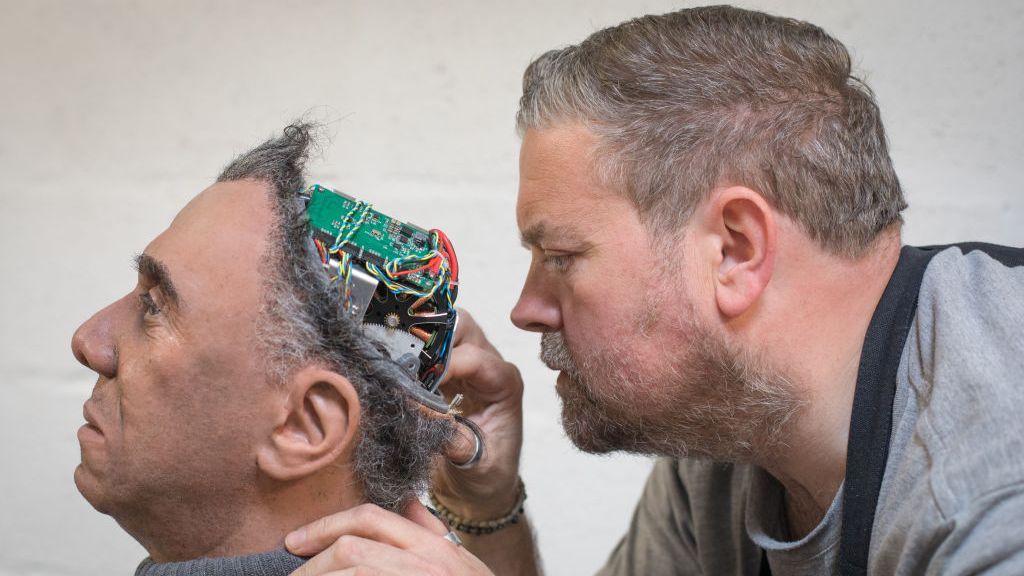 Engineered Arts prosthetic expert Mike Humphrey checks on Fred, a recently completed Mesmer robot that was built at the company's headquarters in Penryn on May 9, 2018 in Cornwall, England. (Photo by Matt Cardy/Getty Images)