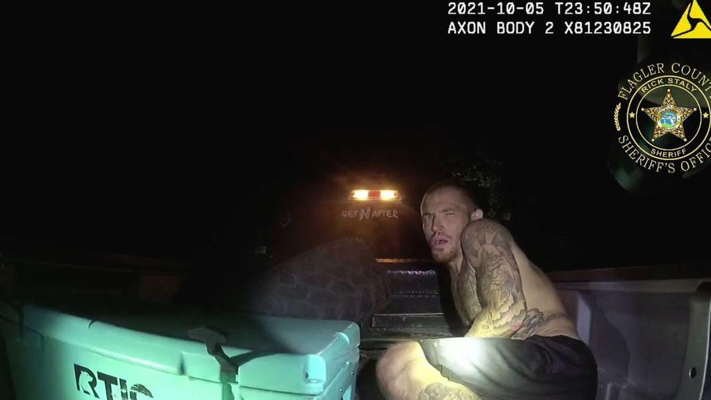 Authorities found Eric Marcotte apparently asleep in the back of a bucket truck in Flagler County, Florida. Soon after this image was taken, he bolted from sheriff's deputies. (Flagler County Sheriff's Office/Zenger News)