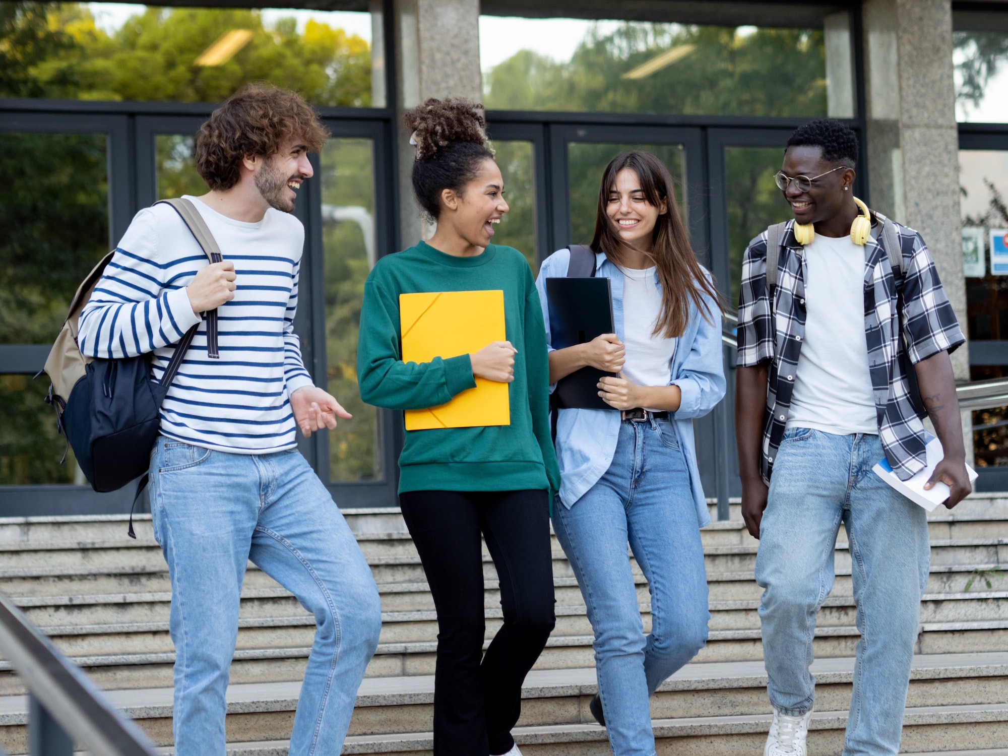 Group of diverse college students talking to each other and walking on campus
