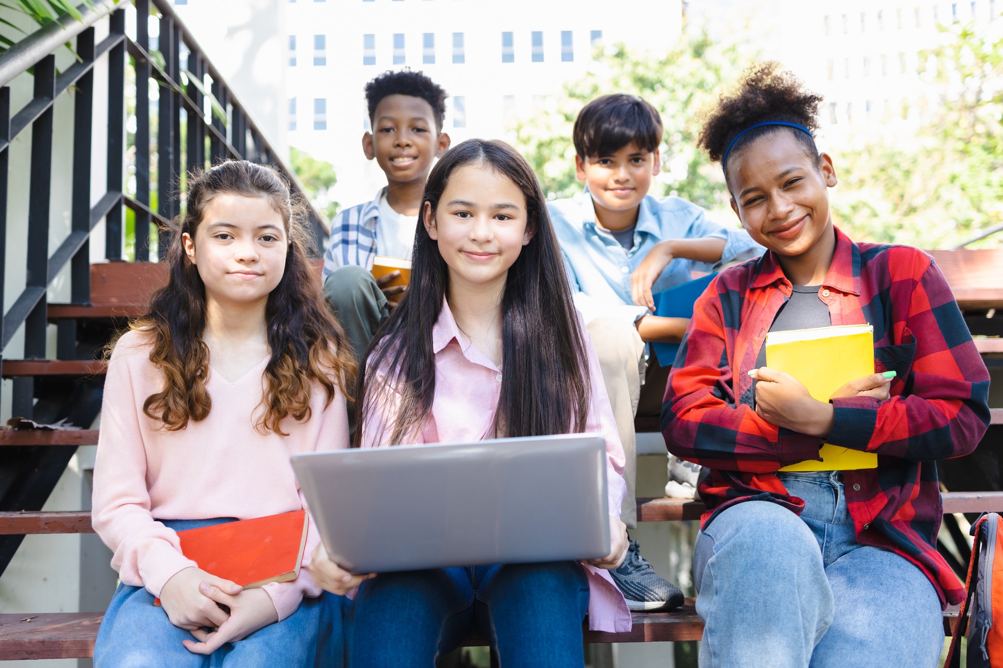 High school students of different races studying with laptops, diverse high school students