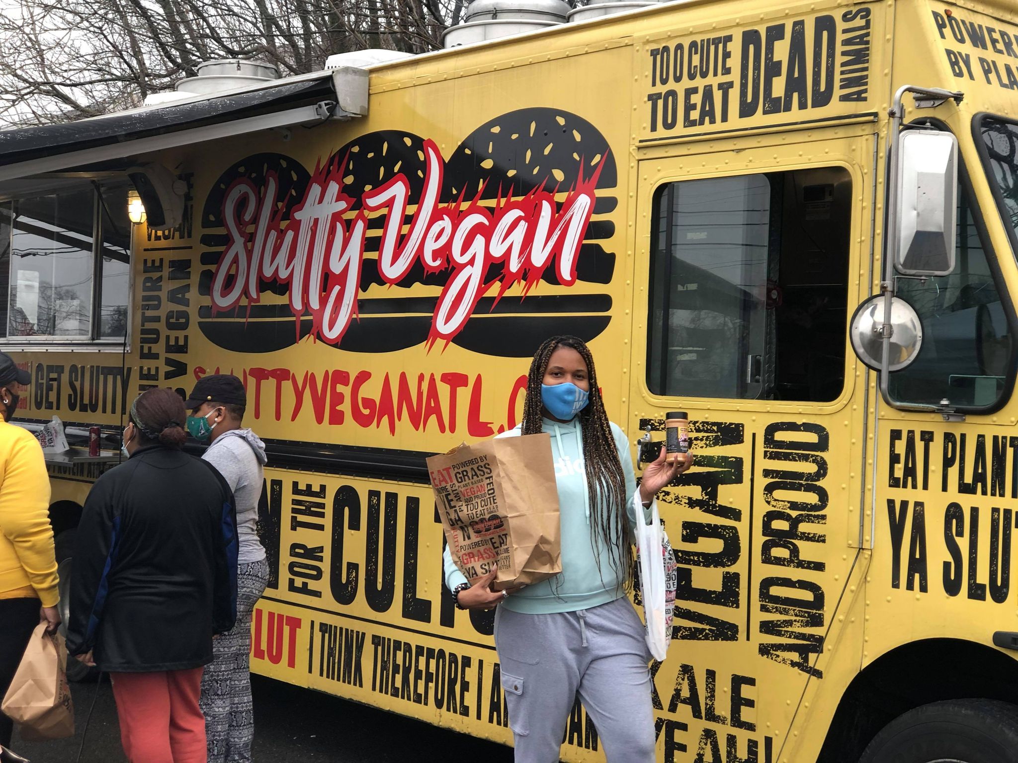 Keosha Thomas standing in front of the Slutty Vegan food truck pop up in Nashville, TN